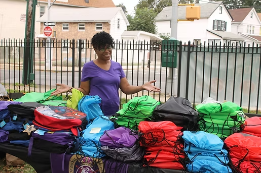 Destiny Bound backpack giveaway table with colorful bags